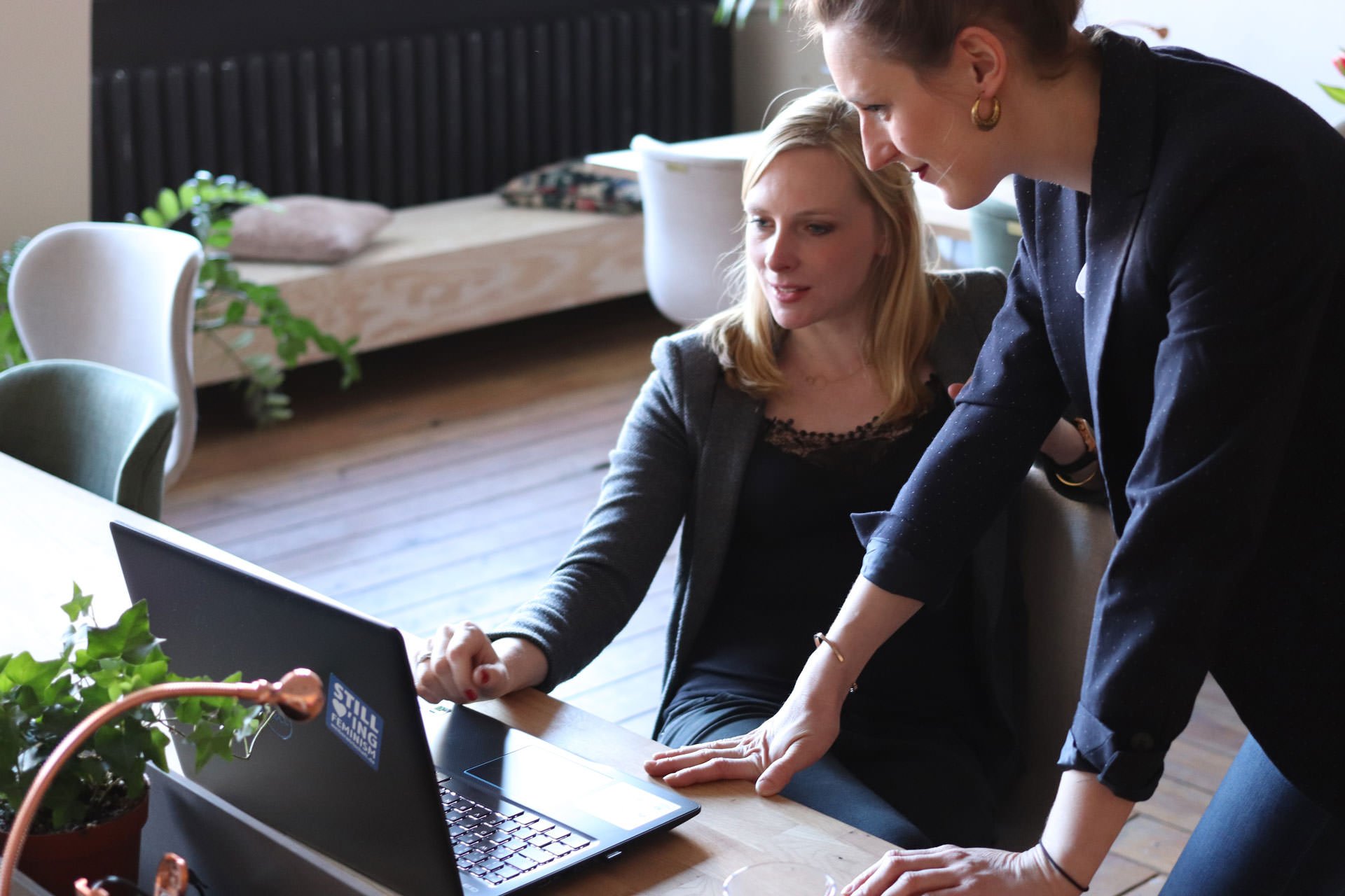 A man and a woman looking at a computer screen